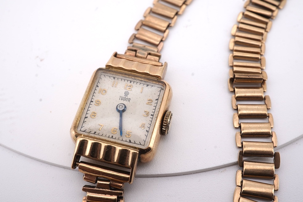 A lady's 1950's 9ct gold Tudor manual wind wrist watch, with Arabic dial, case diameter 18mm, on a damaged 9ct gold bracelet, gross weight 18.6 grams, together with a lady's 18ct gold Buren manual wind wrist watch, on a